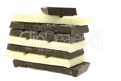 Tiles of dark and white chocolate isolated on white