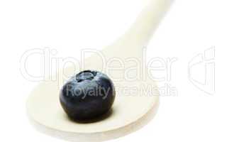 blueberries in a wooden spoon isolated on white