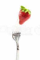 Strawberry on fork isolated on white