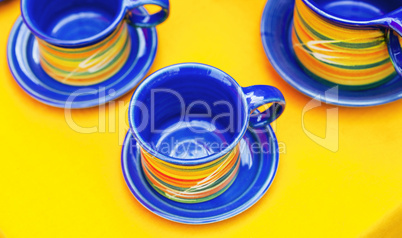 ceramic cups on a yellow background