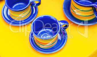 ceramic cups on a yellow background