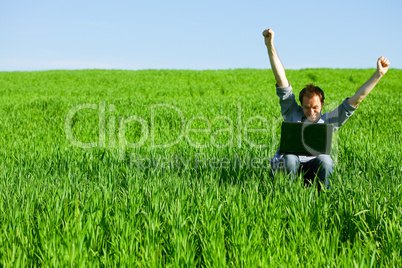 Young man using a laptop outdoors