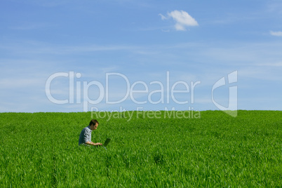 Young man using a laptop outdoors