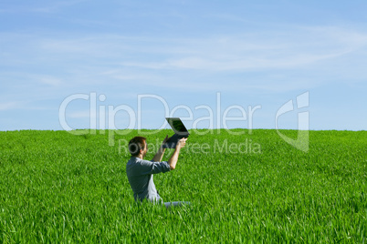 Young man using a laptop outdoors