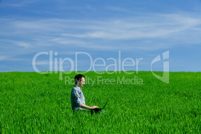 Young man using a laptop outdoors