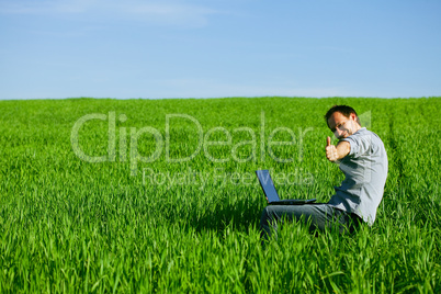 Young man using a laptop outdoors