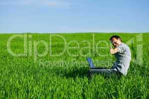 Young man using a laptop outdoors