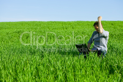 Young man using a laptop outdoors