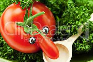 tomato with a nose lying on a green plate with a spoon