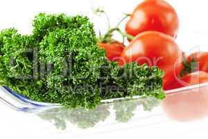 tomatoes and herbs in a glass