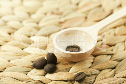 wooden spoon and coffee beans are on the wicker material