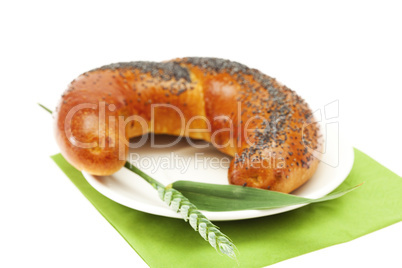 bread with poppy seeds and the spike isolated on white