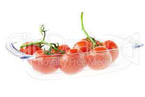 a bunch of tomatoes in a glass isolated on white