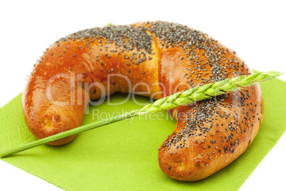 bread with poppy seeds and the spike isolated on white