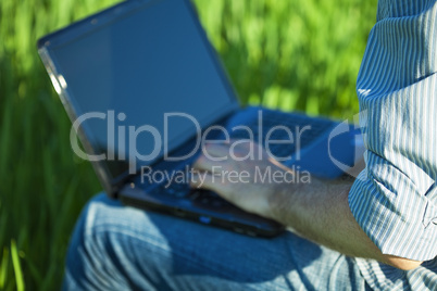 hand of a man working for a laptop