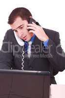 Isolated Stressed Businessman At His Desk Working - White Background .