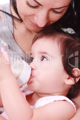 Mother and baby drinking milk from bottle in a white background. Mother and baby drinking milk from bottle in a white background.