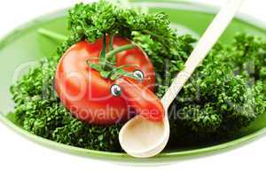 tomato with a nose on the plate and the green isolated on white