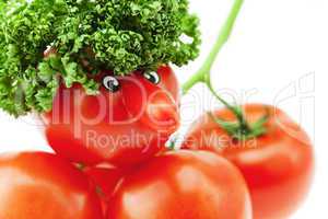 tomato with a nose and a bunch of tomatoes and herbs isolated on