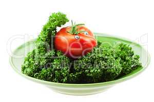 tomato  with the nose on a green plate isolated on white