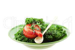 tomato  with the nose on a green plate isolated on white