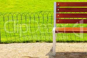wooden bench against a background of green field