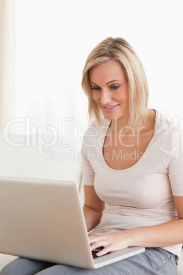 Portrait of a smiling woman using a laptop