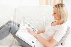 Blonde woman reading a magazine