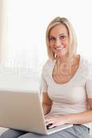 Portrait of a blonde woman using a laptop
