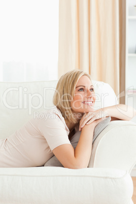 Portrait of a beautiful woman lying on her sofa