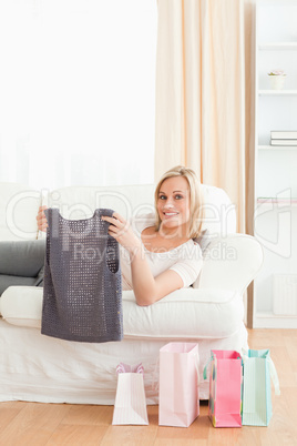 Portrait of a woman holding the clothes she bought