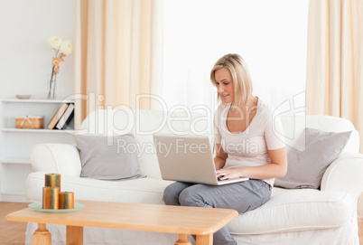 Blonde woman using a laptop