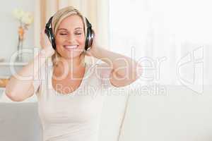 Blond-haired woman listening to music