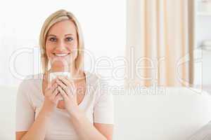 Smiling woman holding a cup of tea