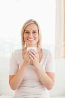 Portrait of a smiling woman holding a cup of tea