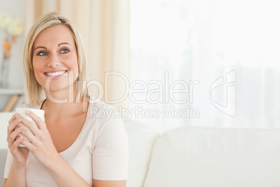 Portrait of a cute woman drinking coffee