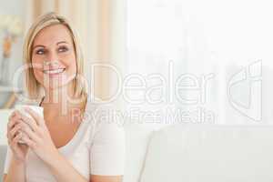 Portrait of a cute woman drinking coffee