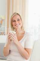Portrait of a charming woman holding a cup of tea