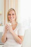 Portrait of a charming woman holding a cup of coffee