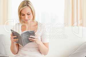 Fair-haired woman reading a book