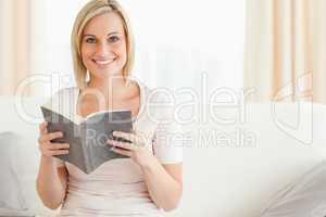 Fair-haired woman with a book