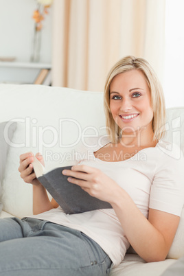 Portrait of a smiling woman with a book