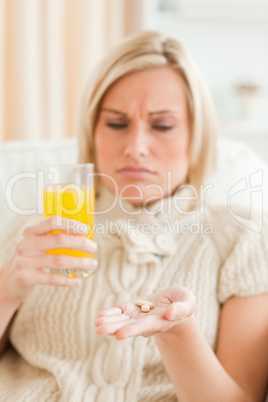Sick woman showing pills