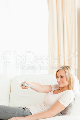 Portrait of a woman using a remote