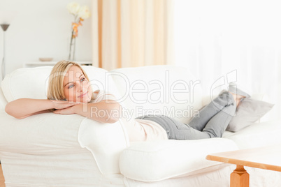 Calm woman lying on her sofa