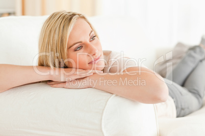Serene woman lying on her sofa