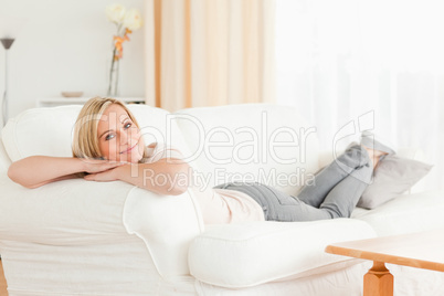 Relaxed woman lying on her sofa