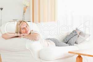 Relaxed woman lying on her sofa