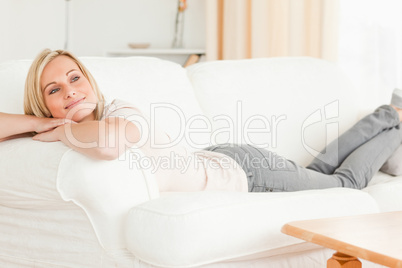 Peaceful woman lying on her sofa