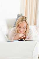 Portrait of a blonde woman reading a magazine